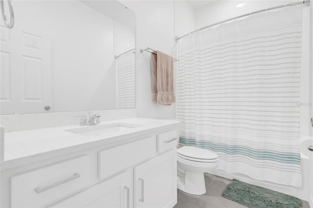 bathroom featuring tile patterned floors, vanity, and toilet