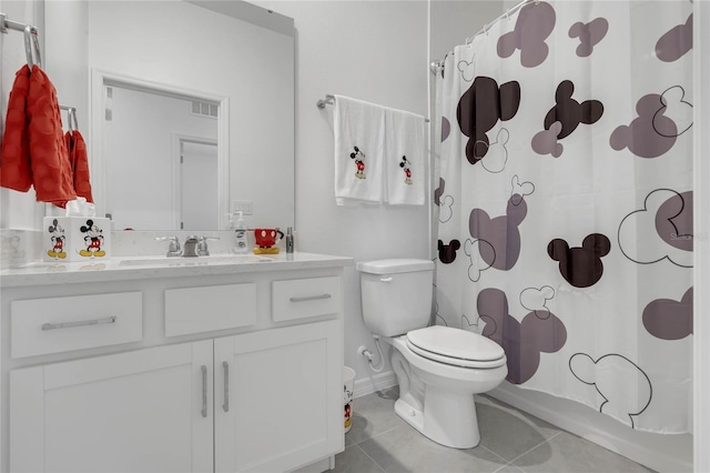 bathroom featuring tile patterned floors, vanity, and toilet