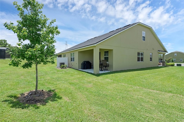 back of property featuring a lawn and a patio area