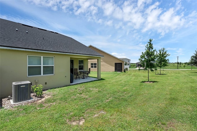 view of yard featuring central air condition unit and a patio