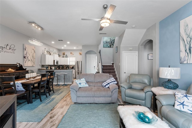 living room with ceiling fan and light hardwood / wood-style flooring