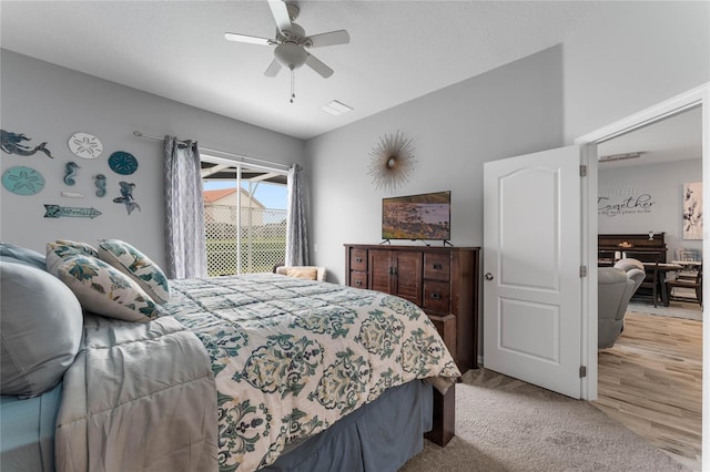 bedroom with ceiling fan and light carpet