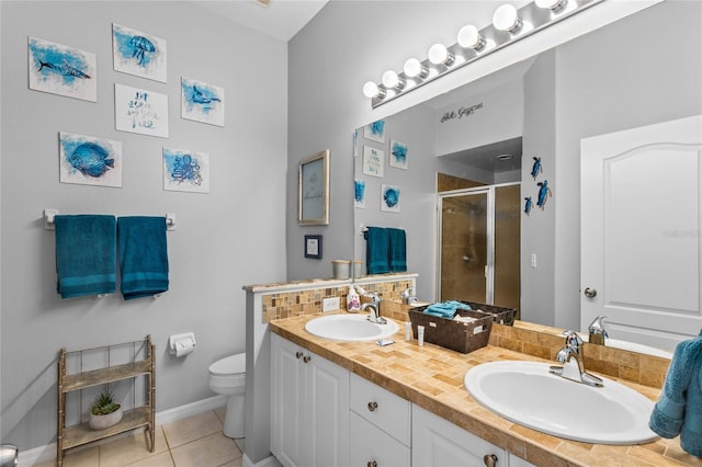 bathroom featuring an enclosed shower, vanity, decorative backsplash, tile patterned floors, and toilet