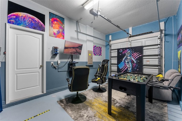 game room featuring concrete flooring, electric panel, and a textured ceiling