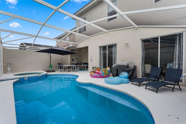 view of pool featuring a grill, a lanai, a patio, and an in ground hot tub