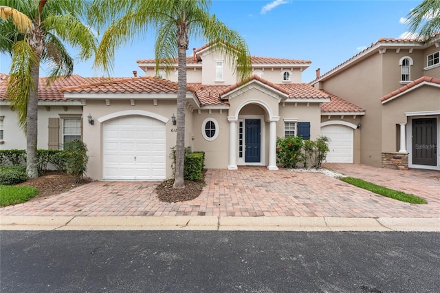 mediterranean / spanish-style house with a garage