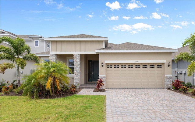 view of front of house featuring a front yard and a garage