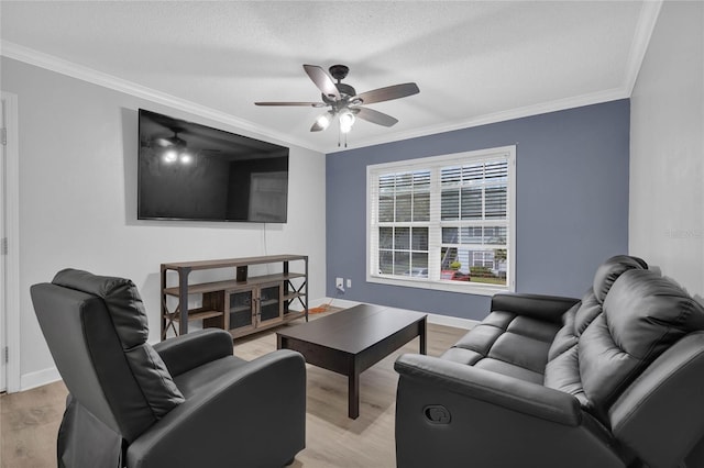 living room featuring light hardwood / wood-style floors, a textured ceiling, ceiling fan, and ornamental molding