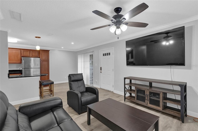 living room featuring ceiling fan, light hardwood / wood-style flooring, and ornamental molding