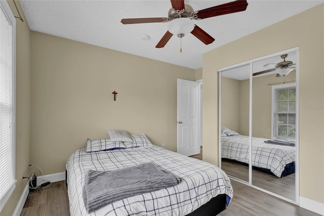 bedroom featuring a closet, ceiling fan, and wood-type flooring