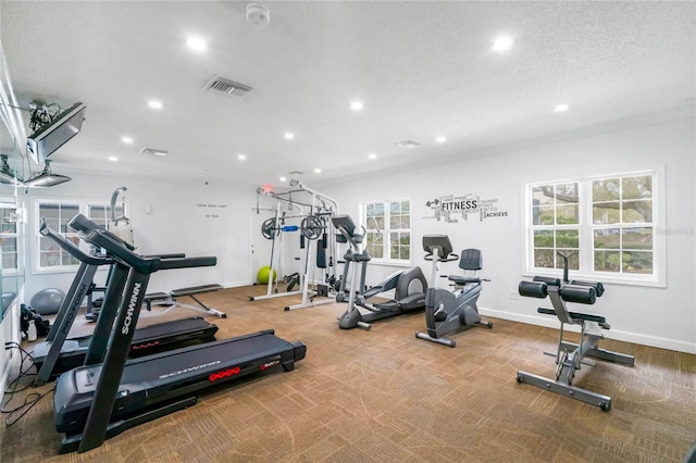 gym featuring a textured ceiling and carpet flooring