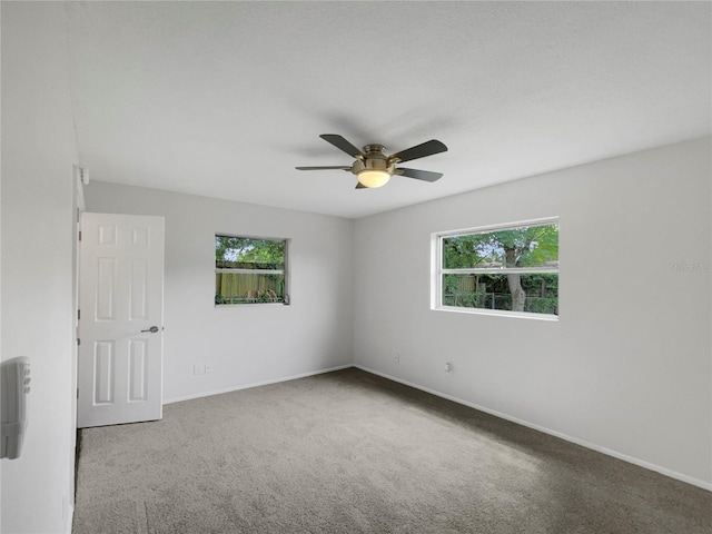 unfurnished room with carpet floors and ceiling fan