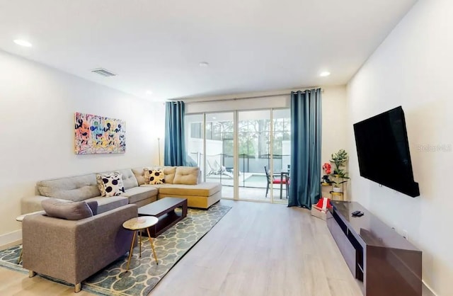 living room featuring floor to ceiling windows and wood-type flooring