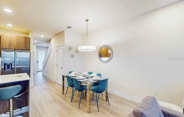 dining space with light hardwood / wood-style flooring