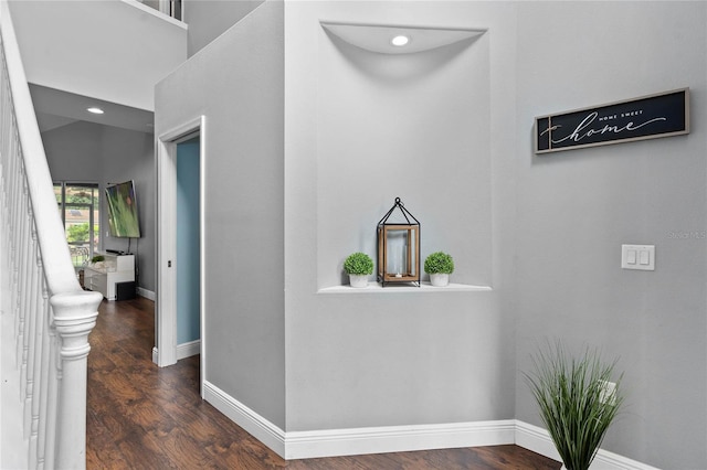 hallway with dark hardwood / wood-style floors