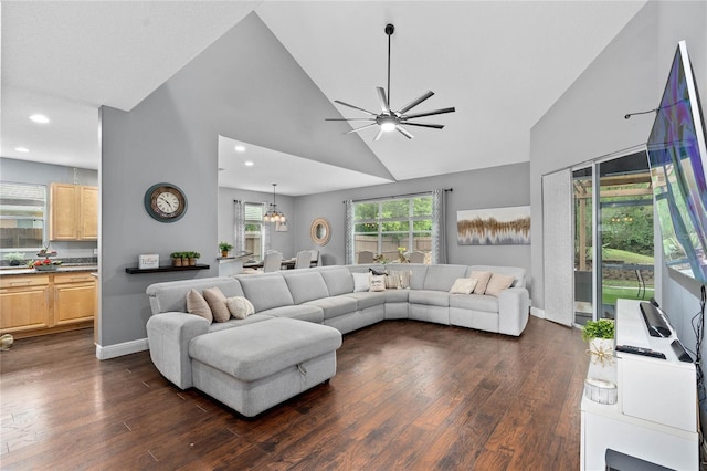 living room featuring dark hardwood / wood-style flooring, high vaulted ceiling, and ceiling fan