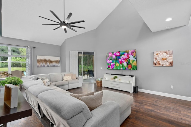 living room featuring dark hardwood / wood-style flooring, high vaulted ceiling, and ceiling fan