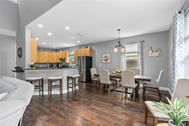 dining room featuring dark hardwood / wood-style floors and a notable chandelier