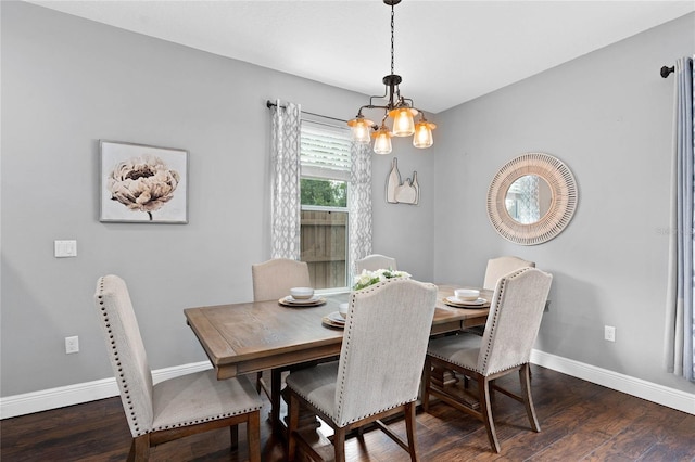 dining space with dark hardwood / wood-style floors and a notable chandelier