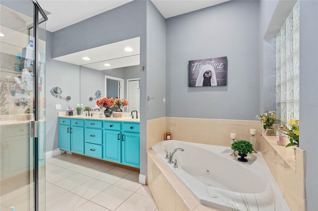 bathroom with tile patterned flooring, vanity, and shower with separate bathtub