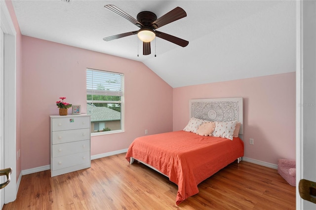 bedroom featuring ceiling fan, lofted ceiling, and light hardwood / wood-style floors