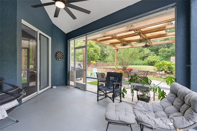 sunroom with ceiling fan and lofted ceiling