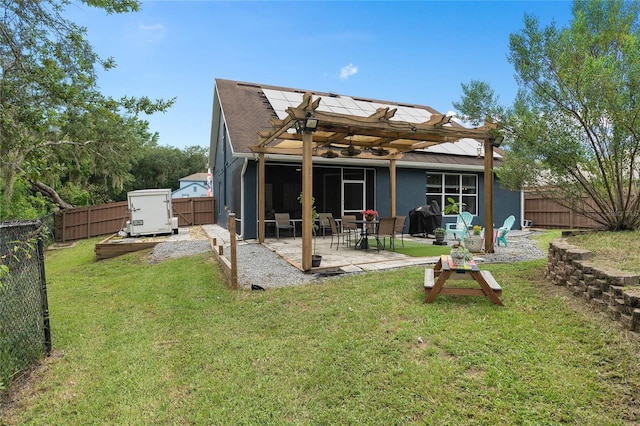 rear view of house with a yard, a pergola, and a patio area