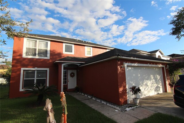 view of front of house featuring a garage and a front lawn