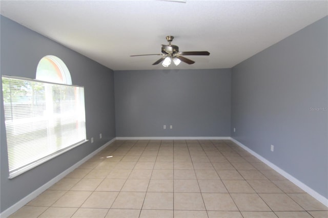 empty room featuring light tile patterned floors and ceiling fan