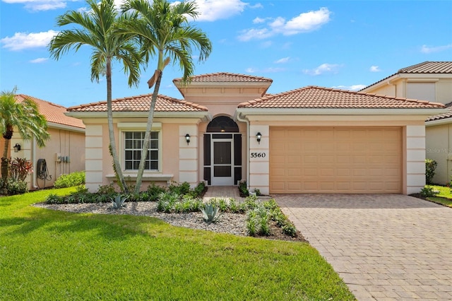 mediterranean / spanish-style house with a front yard and a garage