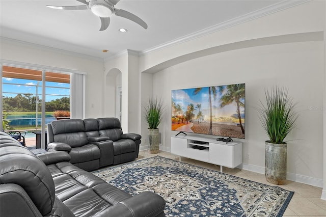 tiled living room with ceiling fan and crown molding