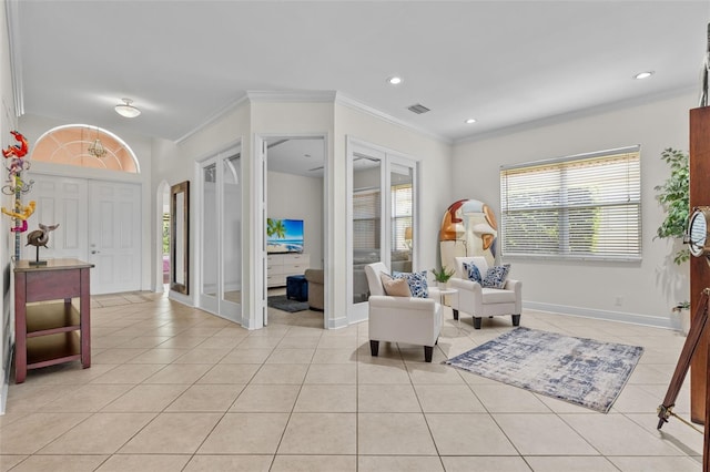 living area with light tile patterned flooring and ornamental molding