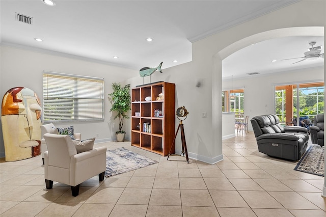 sitting room with ornamental molding, light tile patterned floors, and ceiling fan