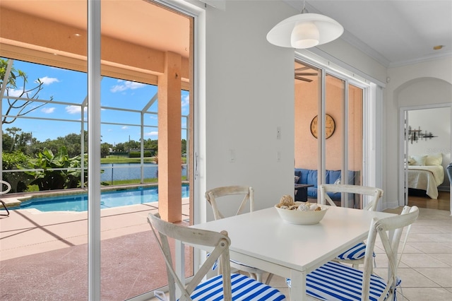 dining space with ornamental molding and light tile patterned floors