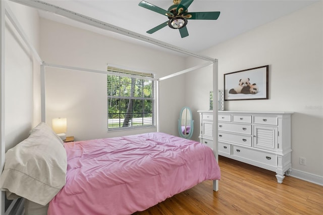 bedroom with ceiling fan and light hardwood / wood-style flooring