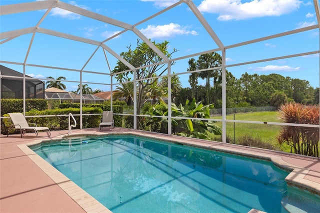 view of swimming pool featuring glass enclosure and a patio area