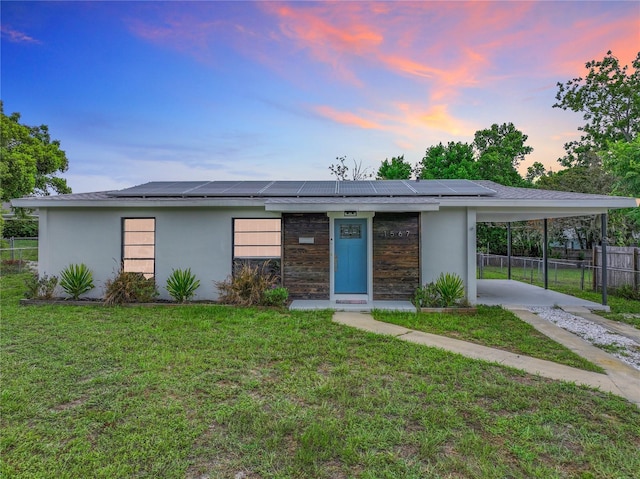 view of front of property featuring a carport and a yard