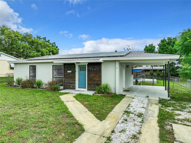 single story home with a carport and a front lawn