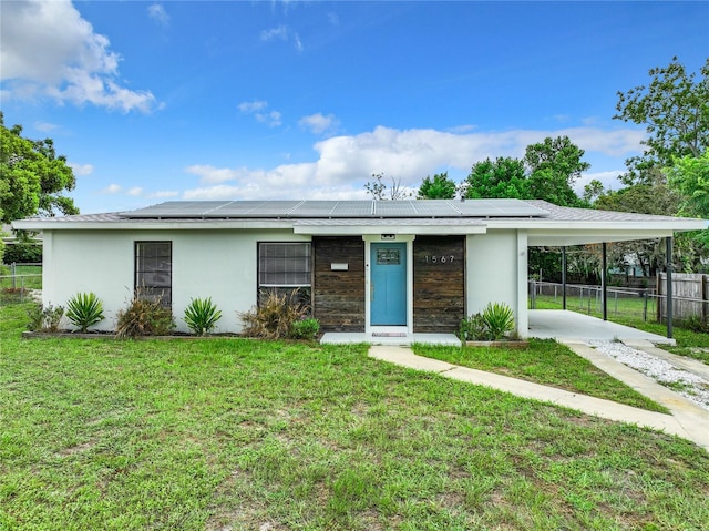 view of front facade with a carport and a front yard