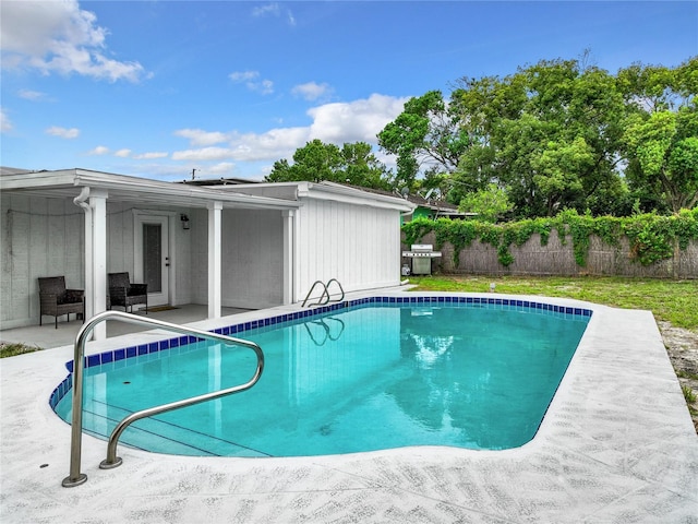 view of pool featuring a patio and grilling area