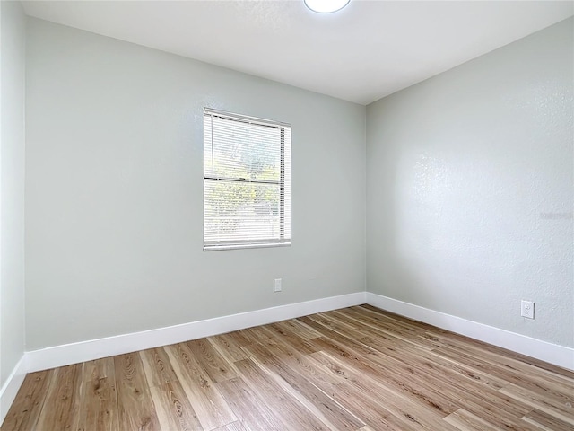 unfurnished room with light wood-type flooring