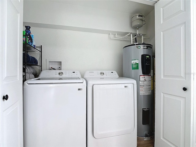 washroom featuring washer and clothes dryer and water heater