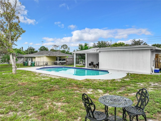 view of swimming pool with a patio area and a lawn