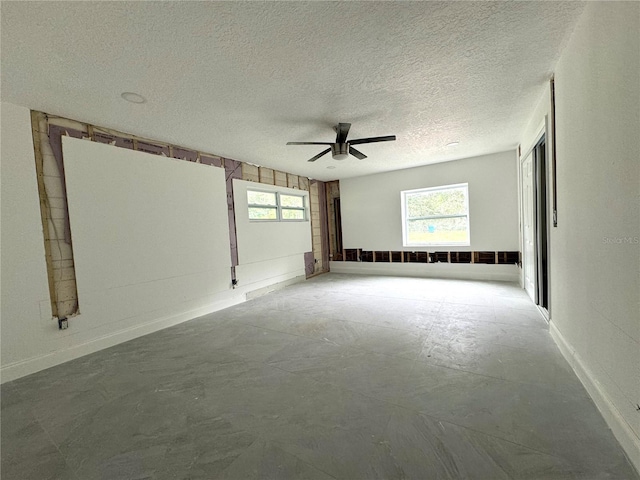 empty room featuring ceiling fan and a textured ceiling