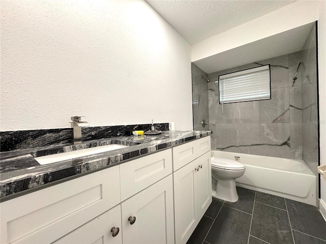 bathroom featuring bathtub / shower combination, vanity, toilet, and a textured ceiling