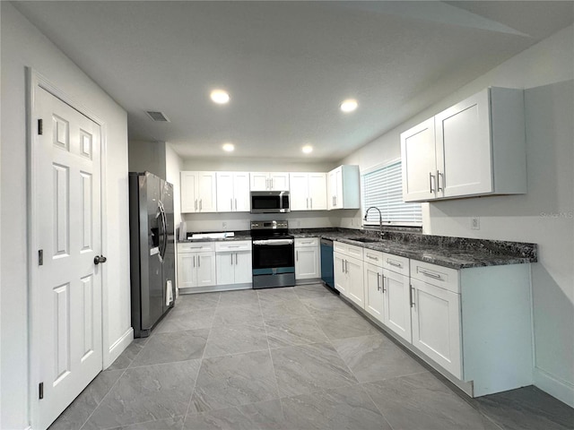 kitchen featuring white cabinetry, stainless steel appliances, and a sink