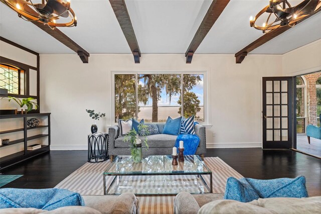 living room with beamed ceiling, dark hardwood / wood-style floors, and a wealth of natural light