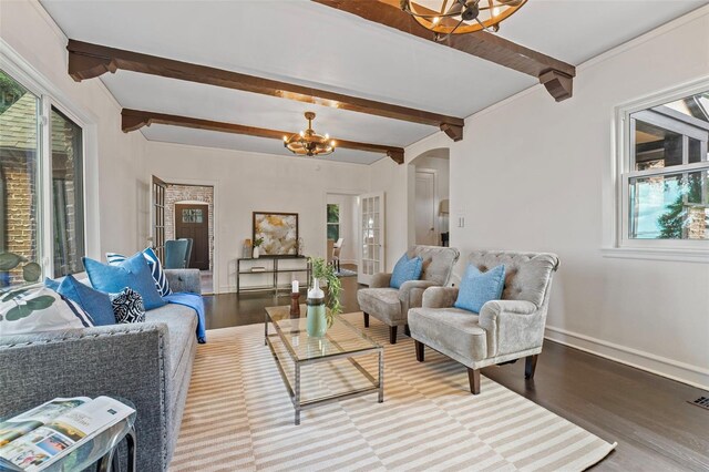 living room with a notable chandelier, wood-type flooring, and beam ceiling