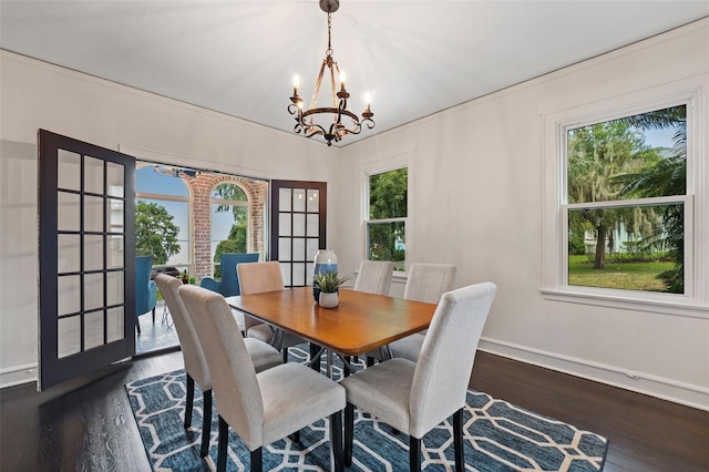 dining area with an inviting chandelier, plenty of natural light, baseboards, and dark wood-style flooring