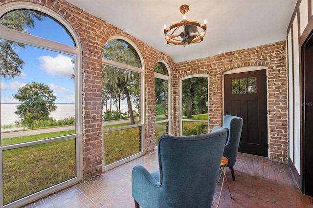 sunroom featuring a chandelier